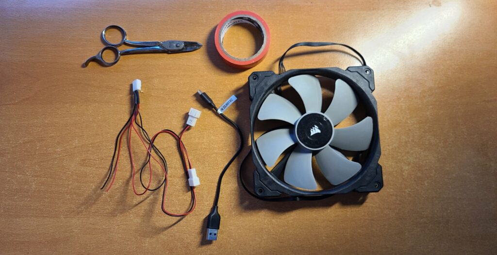 Scissors, red electrical tape, some old PC Fan / USB cables and Corsair ML140.